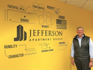 Jim Butz in front of mural - Jefferson Apartment Group